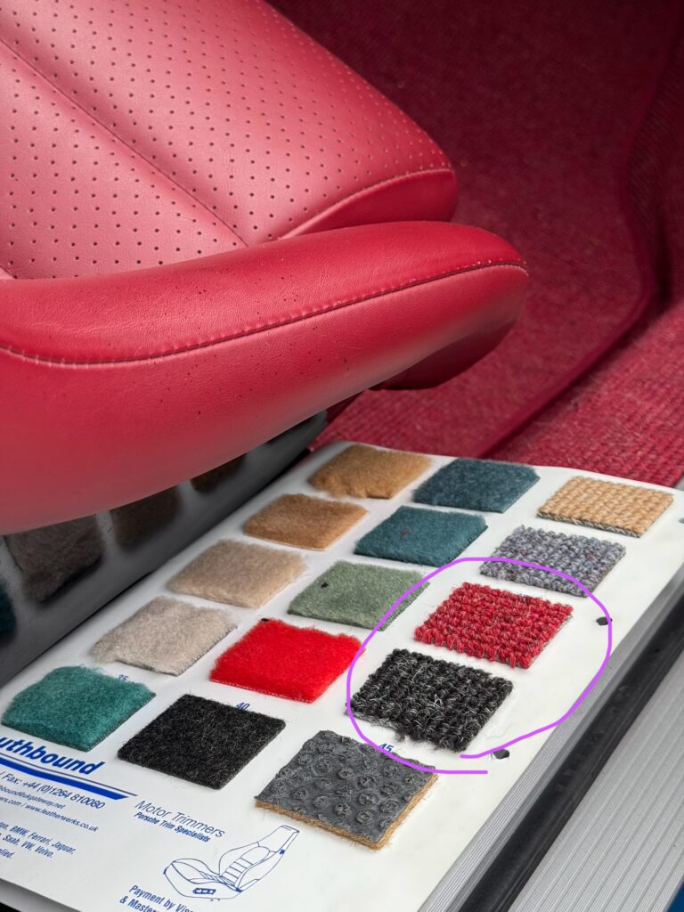 Dark Grey Carpet compliments the red/burgendy leather trim.